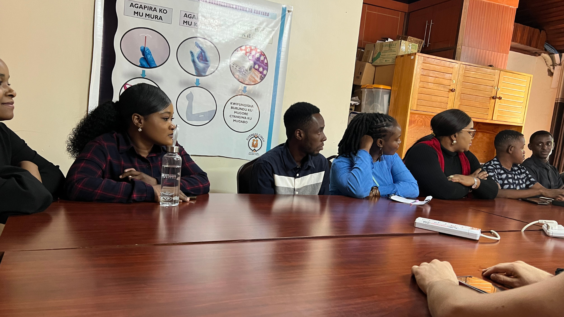 Participants look on in front of table as they learn about the clinic.