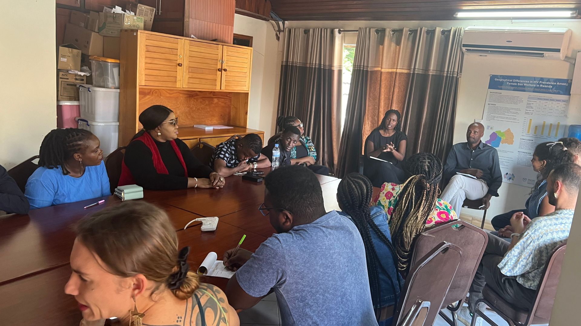 Participants sit around a conference table asking questions.