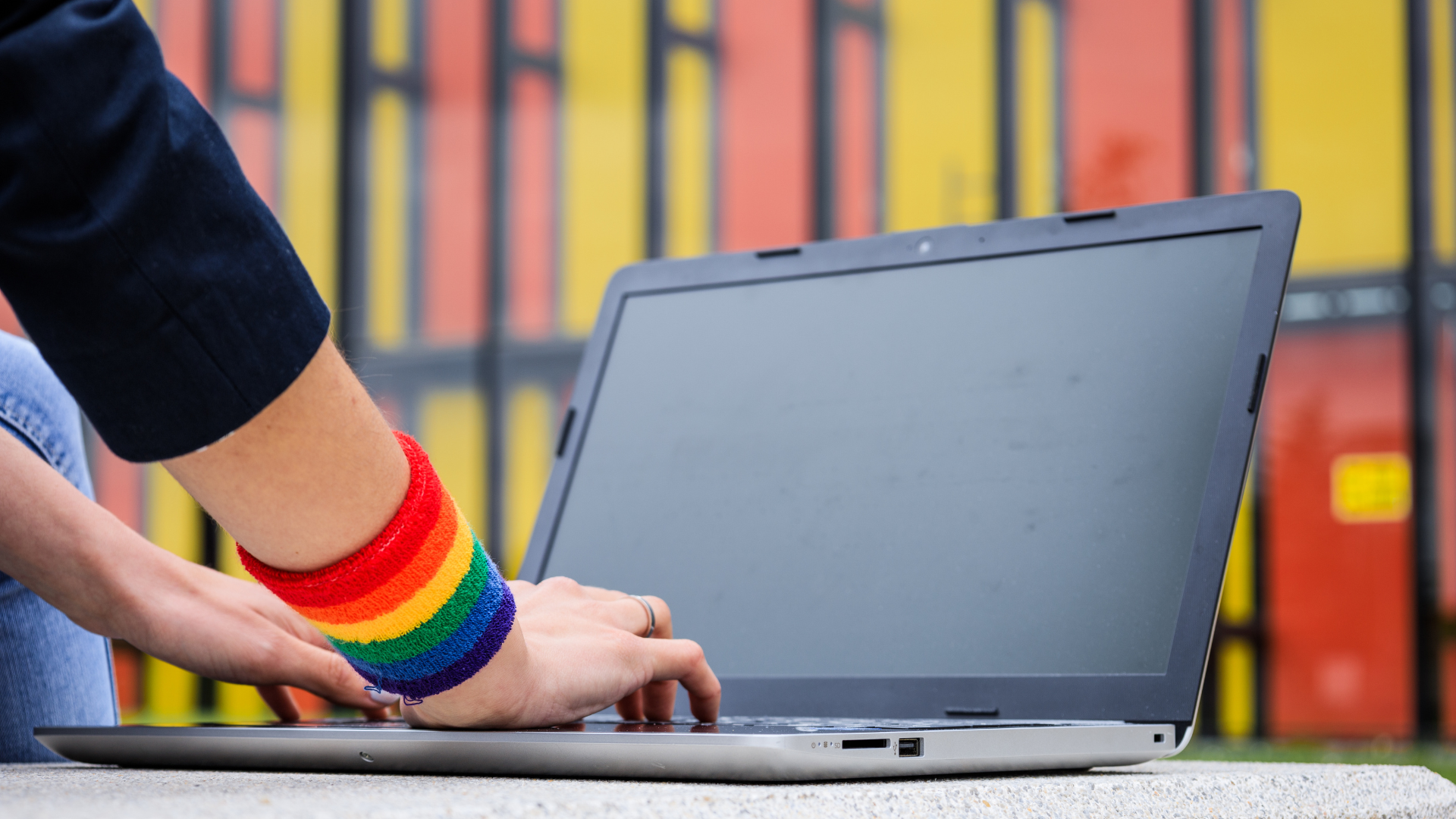 LGBTQ hands on a computer