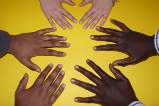 diverse hands on yellow background