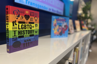 LGBTQ History Book sitting on bookshelf in Yale LGBTQ Center