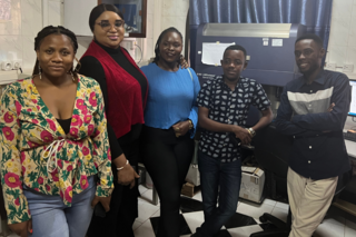 Students pose in front of expensive machine