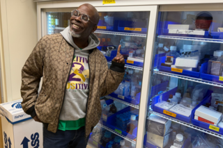 Participant poses in front of cold storage