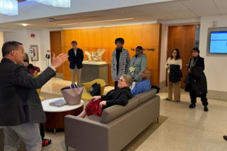 Group learning the history in a discussion in the lobby.