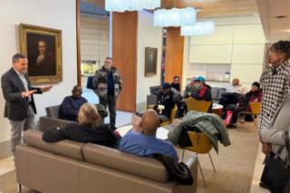Group learning the history in a discussion in the lobby.